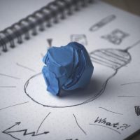 Drawing of a lightbulb with a piece of blue tac at the centre